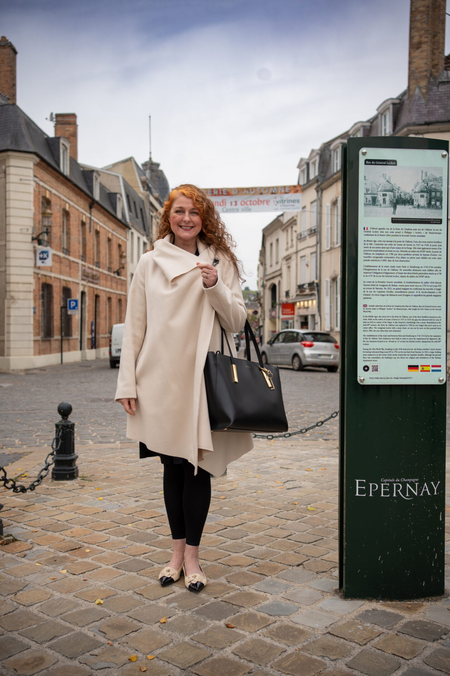 Woman in a cream coat and Pretty ballerina ballerinas exploring the historic centre of Épernay in Champagne, France